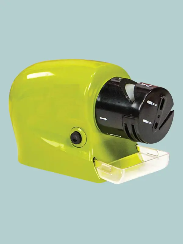 A compact, multicolor electric sharpener with a visible sapphire grinding wheel and a removable metal shavings catch tray